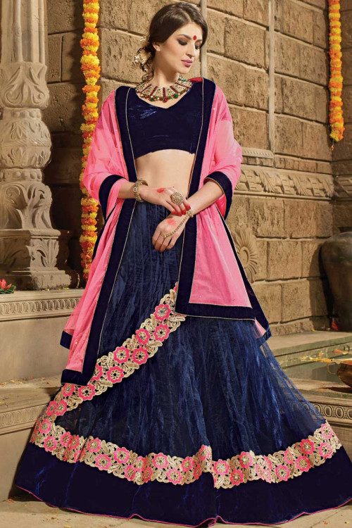 Navy blue velvet blouse matched with coral pink lehenga with attached  draped dupatta only on Kalki