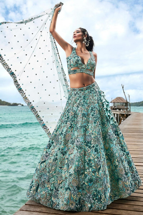Suffuse by Sana Yasir - Tiffany! PKR 195,000 A blue green tulle and silk  lehenga. The lehnga features beautiful flloral jaal and bouquets inspired  from mother nature, rendered using tilla, dabka, naqshi,