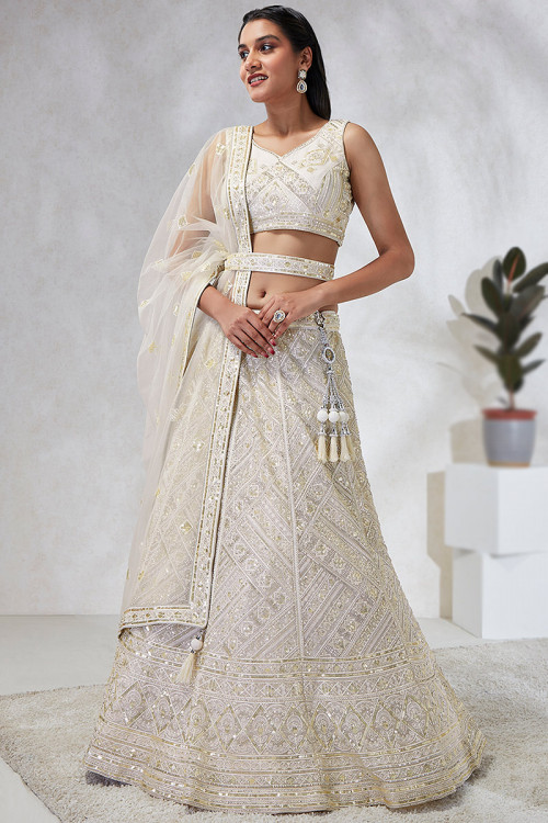 Off White Cutdana Embroidered Party Wear Net Lehenga 
