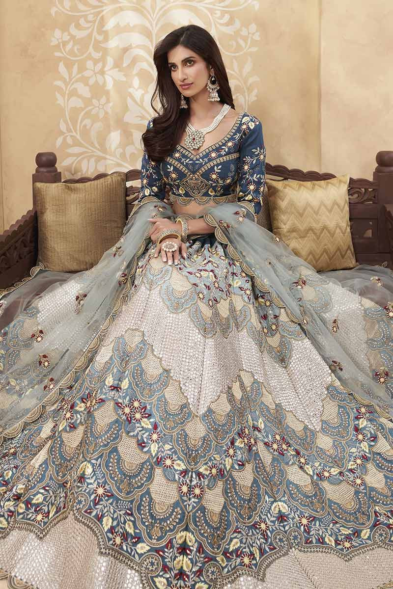 Blue lehenga with multicolor floral jewelry for mehndi.