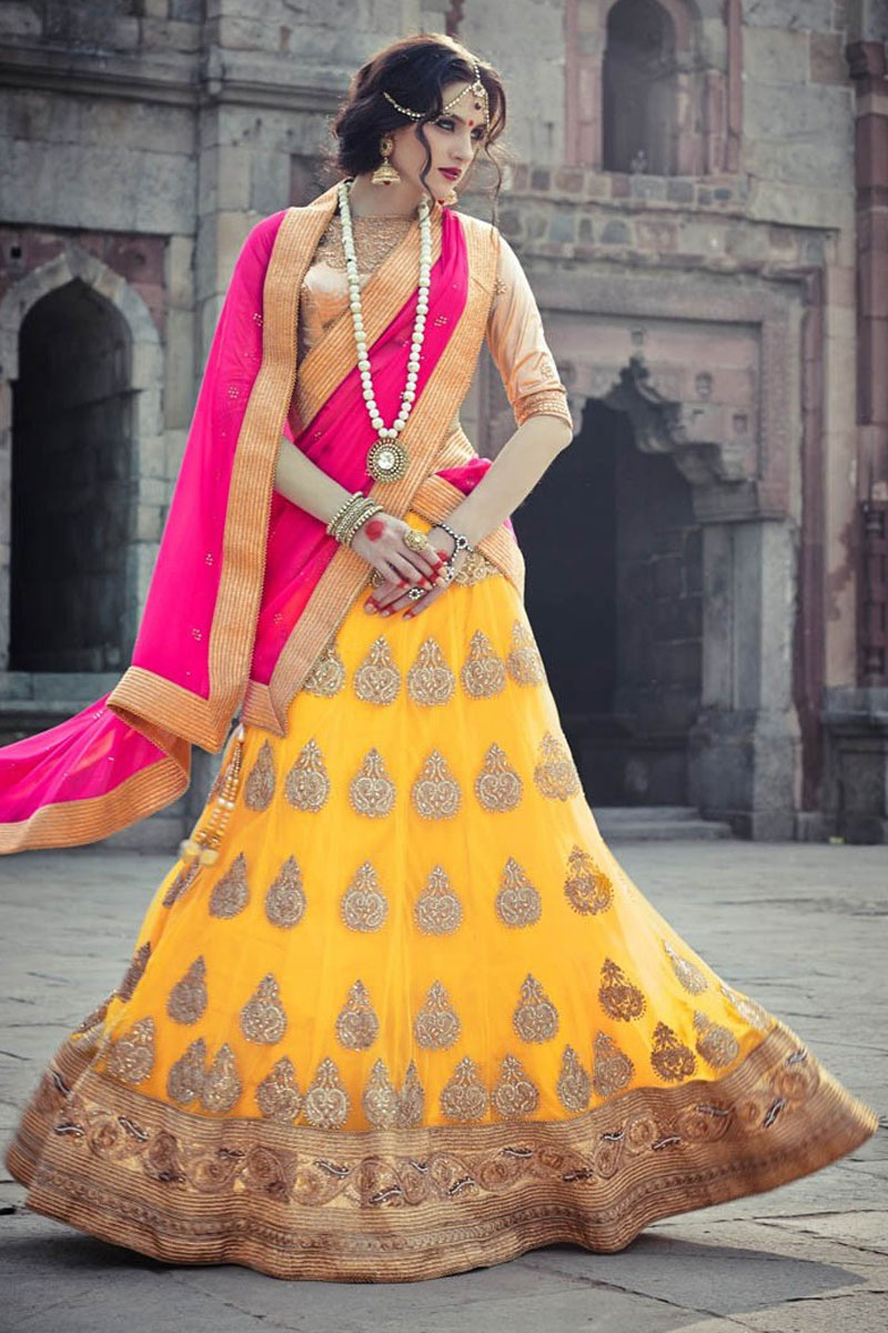 Cream Brasso Lehenga Choli With Pink Net Dupatta Round Neck Blouse Quarter Sleeve Available with malai satin girlish purple color blouse and pink color net dupatta. cream brasso lehenga choli with pink net dupatta