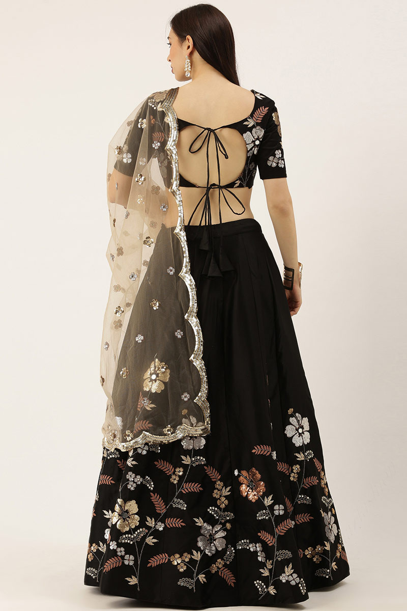 RAVEN BLACK BANARASI LEHENGA SET AND A MIRROR EMBROIDERED BLOUSE PAIRED  WITH A MATCHING BUTI WORK DUPATTA AND GOLD EMBELLISHMENTS. - Seasons India